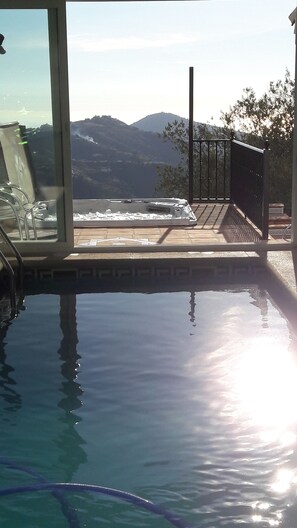 Swim laps in the pool overlooking the majestic mountain landscape from the adjacent balcony.