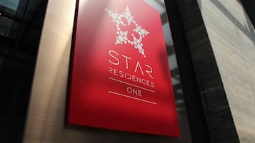 A red sign with the text "STAR RESIDENCES ONE" and a stylized star graphic.