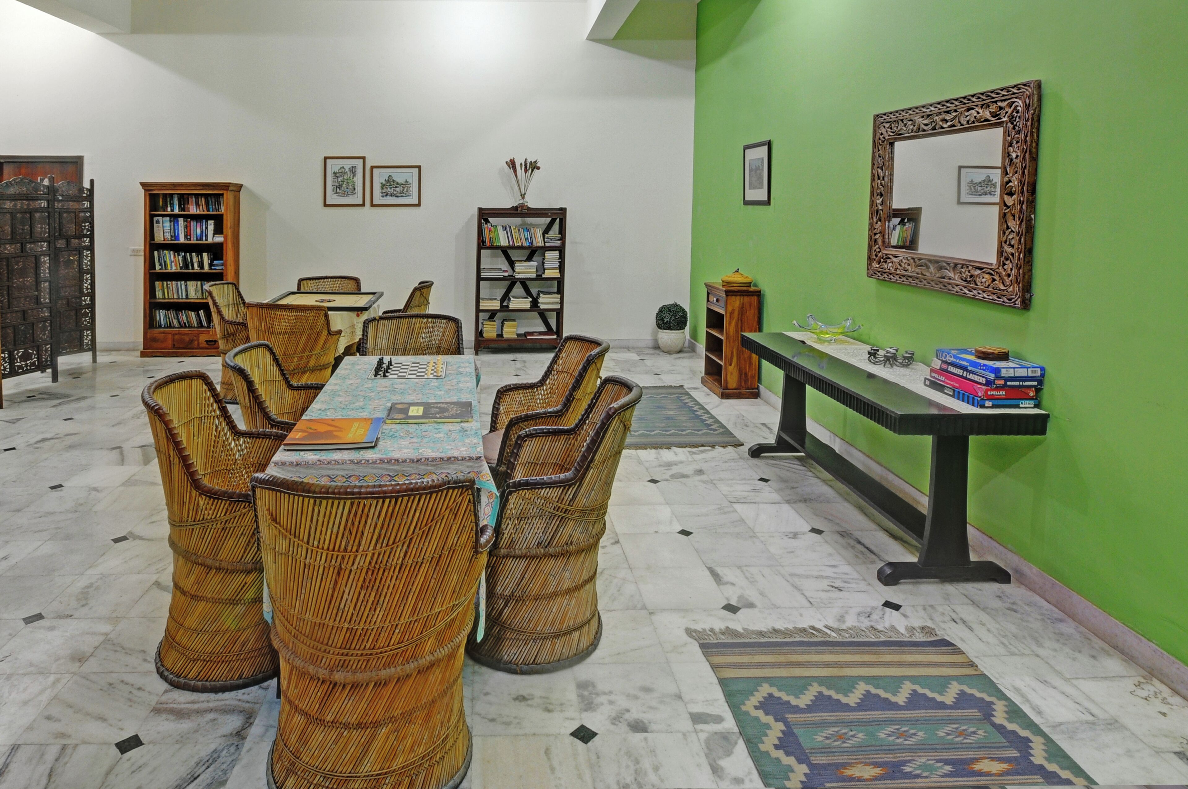 A dining area with a table, chairs, and bookshelves.