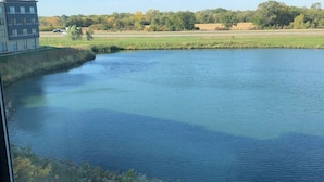 A river with a building on the left and a bridge in the foreground. - Hyatt Place Altoona/Des Moines (Altoona)