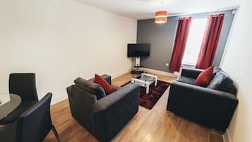 Standard Apartment | Living area | 40-inch flat-screen TV with digital channels, TV