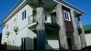 A two-story building with a balcony on the second floor. - Ivon Suites (Lagos)