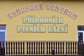 A sign for 'Europské Centrum' with 'Přírodní Pívaní Lážní' written below.