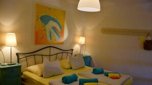 A hotel room with a bed, two bedside tables, lamps, a wall painting, and a hanging bag. - privacy,  unforgettable view, crystal clear water, (Vela Luka)