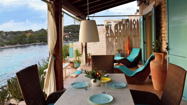 A terrace with wicker furniture, a table set for dining, and a view of the sea. - privacy,  unforgettable view, crystal clear water, (Vela Luka)