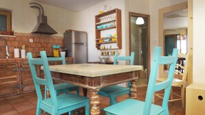 A kitchen with a tiled floor, a wooden table, and turquoise chairs. - privacy,  unforgettable view, crystal clear water, (Vela Luka)