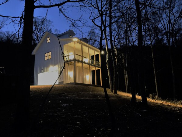 A two-story house with a balcony, surrounded by trees. - Secluded, Cozy Cottage in the Shenandoah Valley (Maurertown)