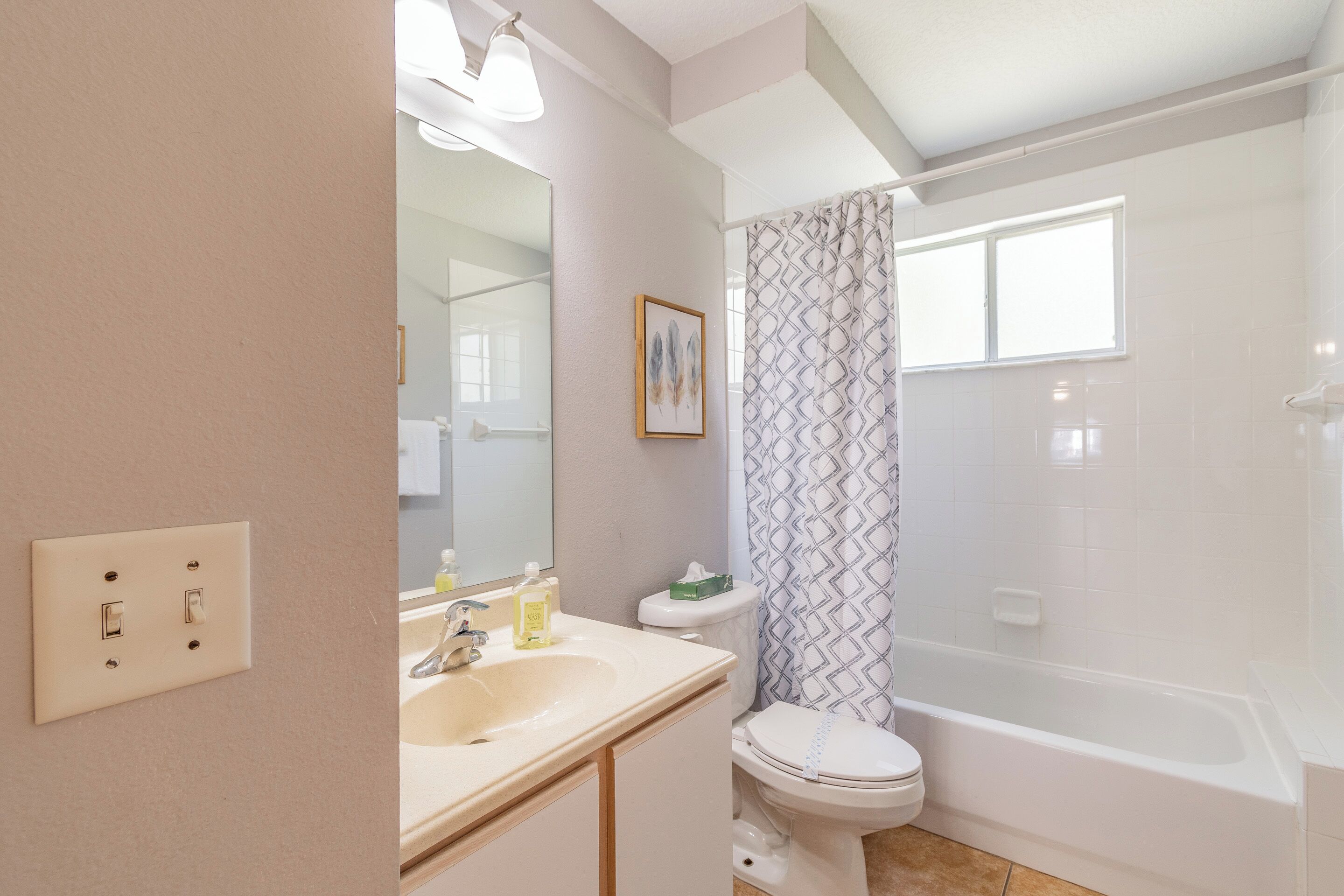 A bathroom with a sink, toilet, and bathtub.