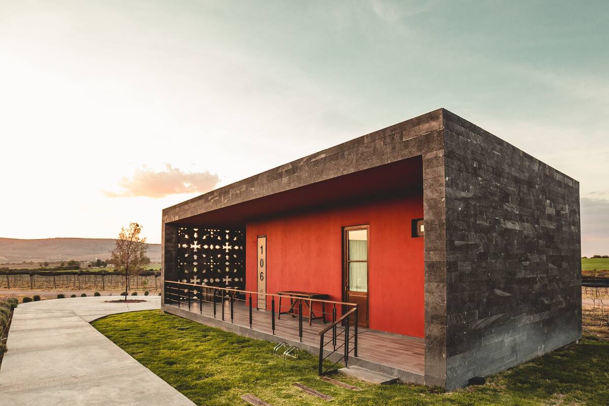 A modern building with a red facade and a stone exterior.