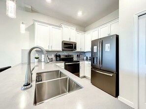 Modern Kitchen with Stainless Appliances and Island Sink