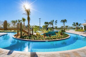 A clear blue pool with a 3 FT depth marker, surrounded by palm trees and a wooden deck.