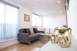 Deluxe Apartment | Living room | Flat-screen TV