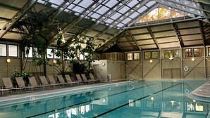 An indoor swimming pool with clear water, surrounded by lounge chairs and potted plants. - 2 Min Walk to the Beach, Pool + Town Square! Rosemary Family Home (Panama City Beach)