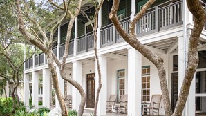 A white colonial-style building with multiple balconies and a covered porch area. - 2 Min Walk to the Beach, Pool + Town Square! Rosemary Family Home (Panama City Beach)