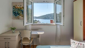 A bedroom with a large window, a desk, a chair, a bed, and a wardrobe. - Holiday Home With Outdoor Hot Tub, Near the Sea (Marina)