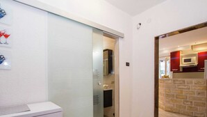 A modern kitchen with a stone backsplash and a microwave. - Apartment 5 km From Trogir's Center (Split)