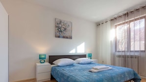 A bedroom with a bed, nightstands, a painting, and a window with curtains. - Holiday Home in Zemunik Donji With Private Pool (Zemunik Donji)