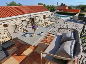 A rooftop terrace with a table, chairs, and a sofa. There is a pool in the background. - Villa in Prkos With Private Pool and Sea Nearby (Škabrnja)