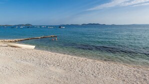 A beach with a clear view of the sea, boats, and distant islands. - Luxury Villa With Private Pool, Great sea View, Near the Beach (Pakostane)