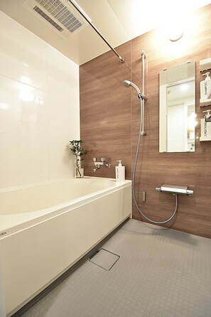 Room (Type C, 1001) | Bathroom | Separate bathtub and shower, deep-soaking bathtub, hair dryer, slippers - Lang Hotel (Tokyo)
