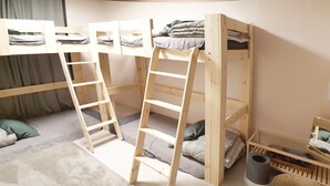 A bunk bed room with a ladder, pillows, a small table, and a basket. - U Guesthouse 2 in Yeonnam Caters to Women - Hostel (Seoul)