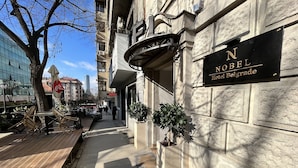 A hotel entrance with a sign reading "Nobel Hotel Belgrade." - Nobel Gallery Hotel (Belgrade)