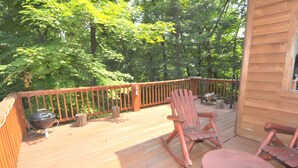 A wooden deck with a grill, chairs, and a table. - Almost Heaven - Cozy and Wonderful (Berkeley Springs)