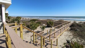 A wooden boardwalk leading to a beach with clear skies. - Oceanfront home with Hot tub and pool table~ 915 W Ashley (Folly Beach)