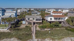 A coastal residential area with houses featuring balconies and decks, some with direct views of the beach and ocean. - Oceanfront home with Hot tub and pool table~ 915 W Ashley (Folly Beach)
