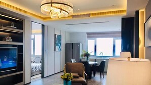 A modern hotel room with a living area, a dining area, and a bedroom. - Himalaya Serviced Residences Nankai Tianjin (Tianjin)