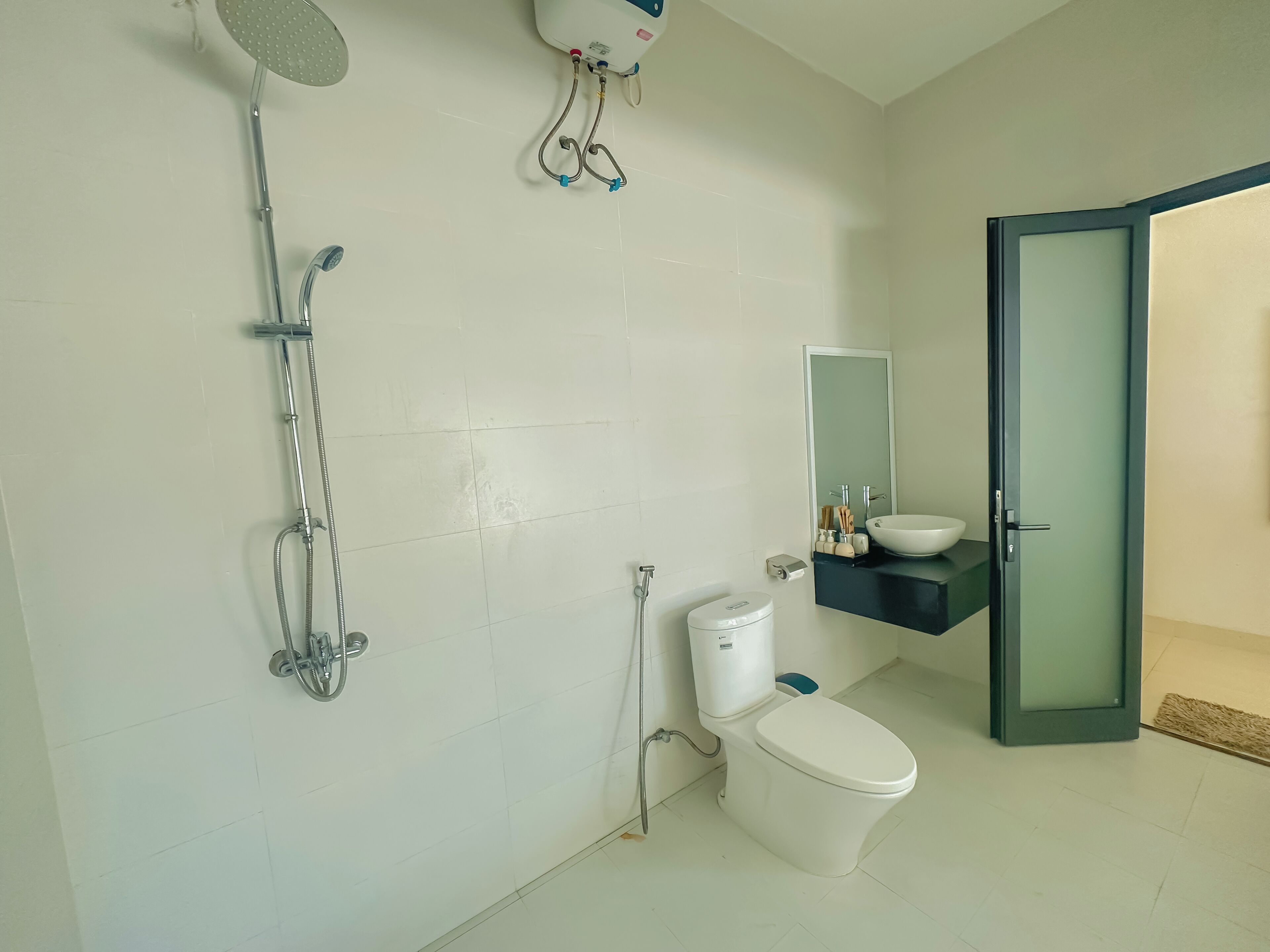 A bathroom with a toilet, a sink, and a shower.