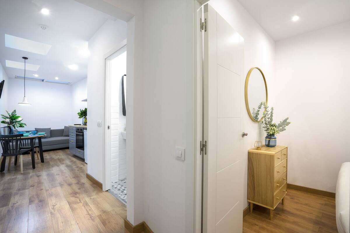 Um apartamento moderno com área de jantar, cozinha e sala de estar.