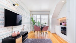 A modern kitchen with white cabinets, a black countertop, and a pink appliance. - CSA18 Premium Design Apartment (Lisbon)