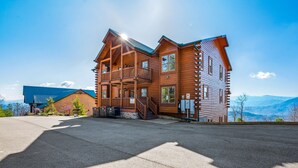 A log cabin with a balcony, a covered porch, and a view of the mountains. - AMAZING VIEW MANOR! Perfect for Weddings and Reunions! (Sevierville)