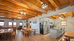 A spacious kitchen with wooden beams, a large island, and modern appliances. - AMAZING VIEW MANOR! Perfect for Weddings and Reunions! (Sevierville)