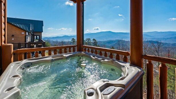 A hot tub with a wooden deck and a scenic mountain view. - AMAZING VIEW MANOR! Perfect for Weddings and Reunions! (Sevierville)