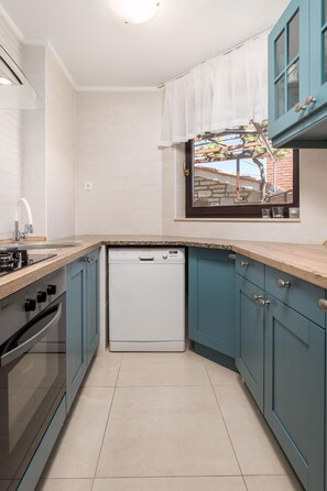 Enjoy cooking in this well-equipped kitchen with a dishwasher, oven, and stovetop.