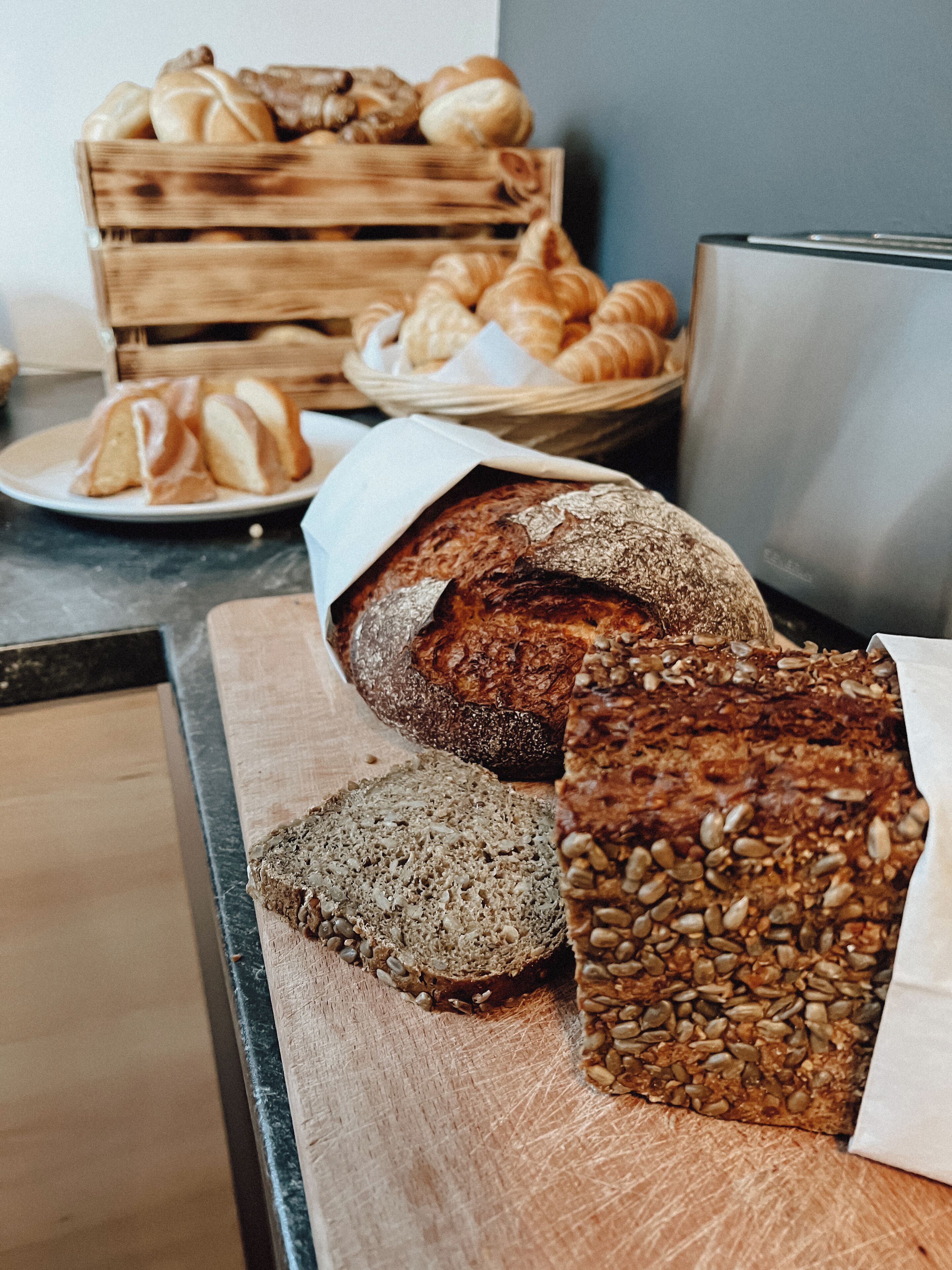 A variety of breads and pastries on a counter.
