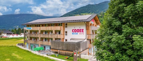 A multi-story building with a sign reading 'COOEE Alpin.'