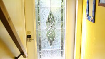 A door with a frosted glass panel and a patterned tile floor.