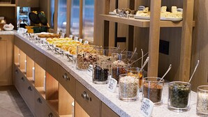 A buffet with various food items and labeled containers. - Paradiso Pure.Living Vegan Hotel (Castelrotto)