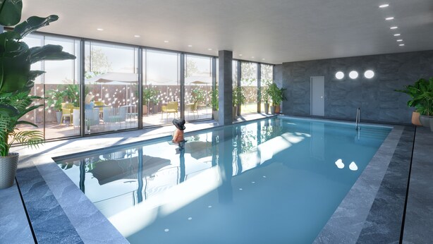 A modern indoor swimming pool with clear glass walls, potted plants, and a view of an outdoor patio area. -  Quarto Verde Apartments (Bergamo)
