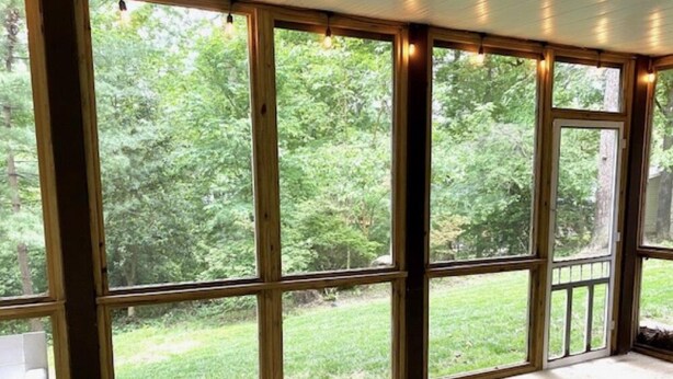 A room with large windows and a wooden floor.