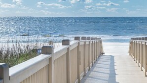 A wooden boardwalk leading to a beach with a clear view of the ocean. - 3326 Villamare -Ocean Front Villa Complex  - Fully Renovated and New Pools! (Hilton Head Island)