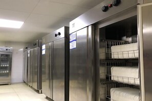 A row of stainless steel refrigerators with shelves inside, likely for food storage. - Hanxin International Hotel (Panjin)