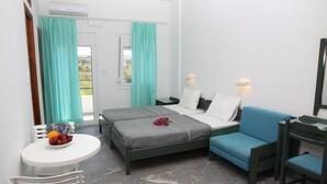 A room with two beds, a small table with fruit, a chair, and a desk with a mirror. - La Palma  VI (Malevizi)