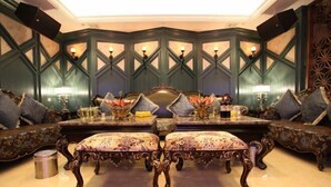 A luxurious room with a large ornate table, two upholstered chairs, and a patterned carpet. - Shen Long Hotel (Hengyang)