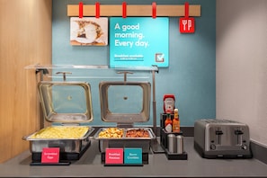 A breakfast buffet with scrambled eggs, breakfast potatoes, and bacon crumbles. - avid hotel Columbus Northwest - Hilliard by IHG (Hilliard)