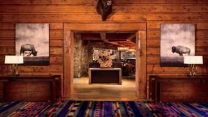 A wooden interior with a central table, two buffalo paintings, and a rustic decor. - Bachelor Gulch Ritz-carlton Hotel Room With Ski in, Ski out Access, Hot Tub, and Full Service Spa (Avon)
