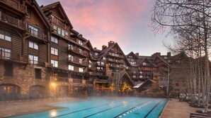 A pool area with a wooden building in the background. - Bachelor Gulch Ritz-carlton Hotel Room With Ski in, Ski out Access, Hot Tub, and Full Service Spa (Avon)